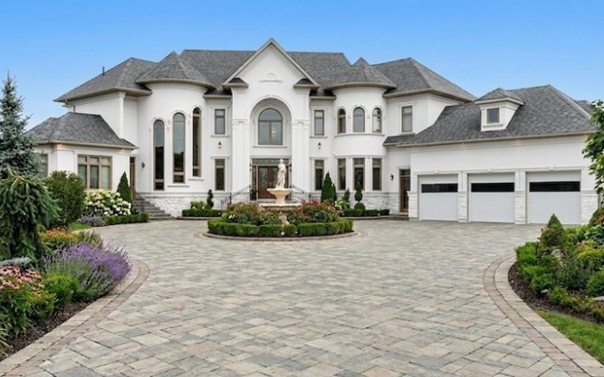 White three-car garage with modern glass-section doors